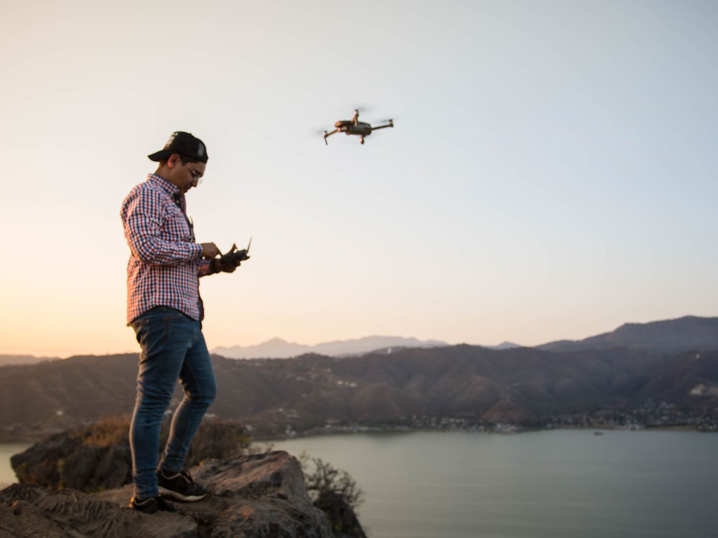 FAA-certified drone pilot operating a drone on a job site